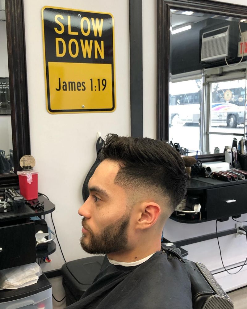 Textured pompadour with skin fade and trimmed beard